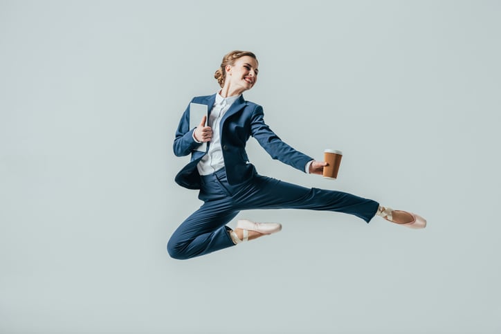 Woman in suit leaps in the air