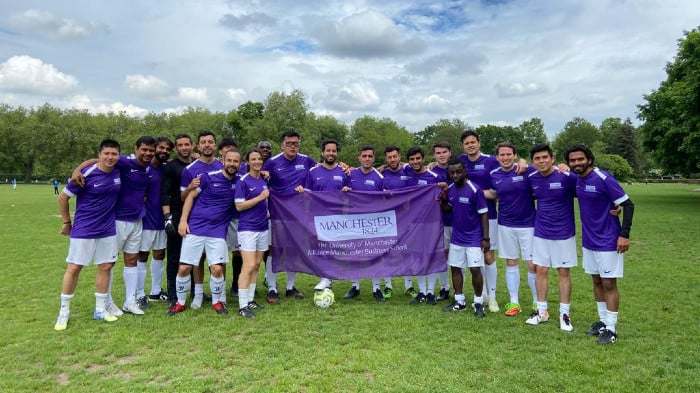 AMBS football team with flag