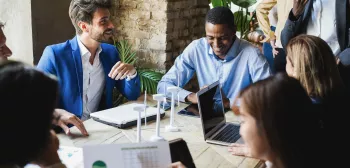 MBA students chat around a table