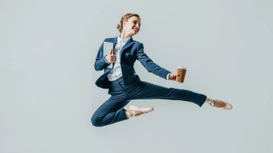 Woman in suit leaps in the air